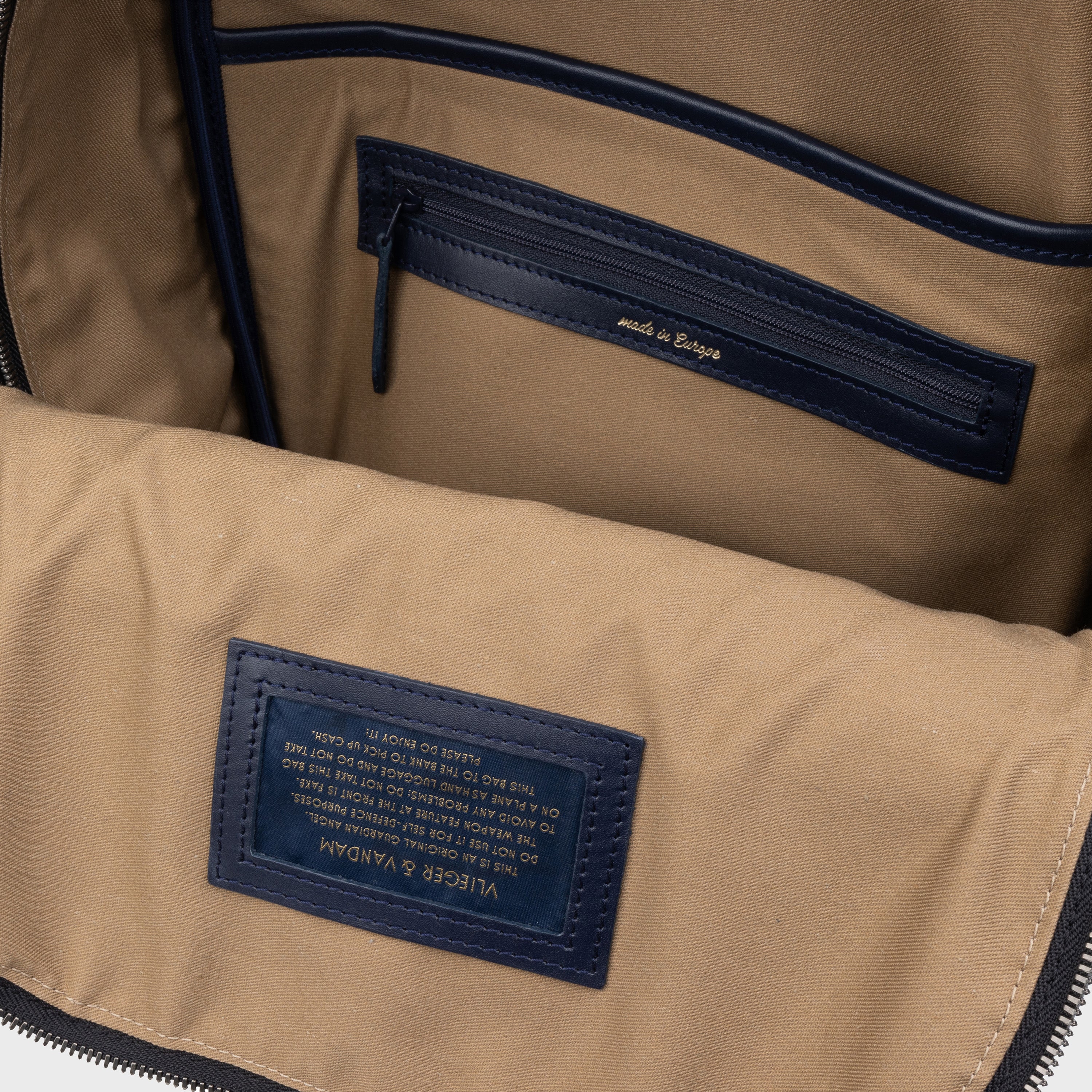 Beige interior with leather details. Signature Vlieger & Vandam warning sign. Made in Europe.
